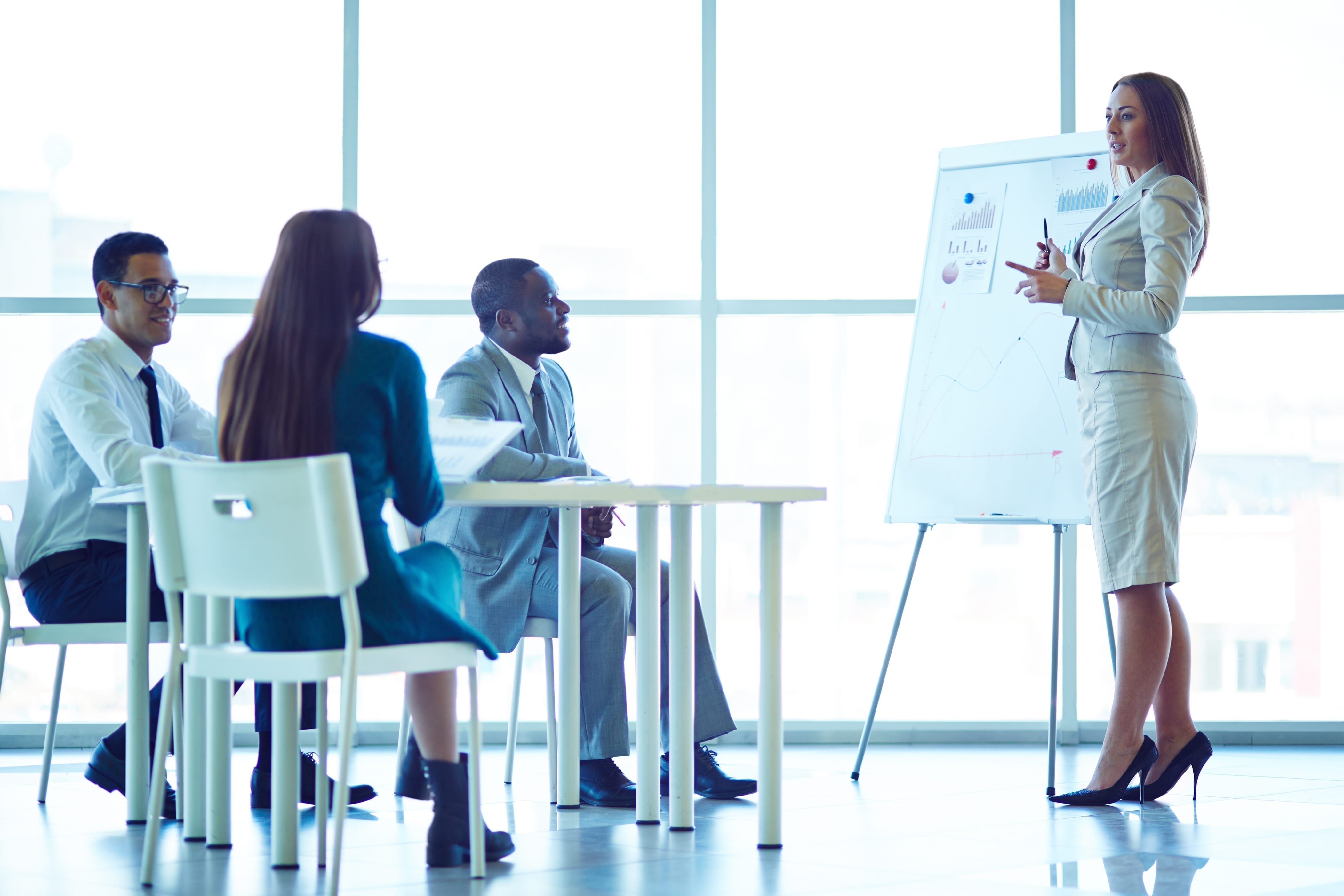 Woman showing financial charts to her colleagues